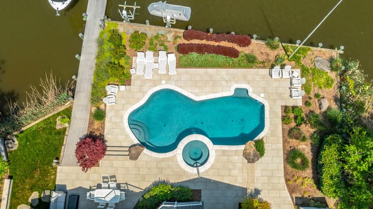 Overhead view of a completed King Cuts pool deck and planting layout, showing the full hardscape footprint